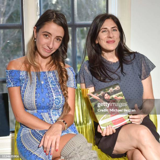 Lauren Francesca and Christine Lusita pose with her book "The Right Fit Formula" at TAP- Giveback Day on January 24, 2019 in Los Angeles, California.