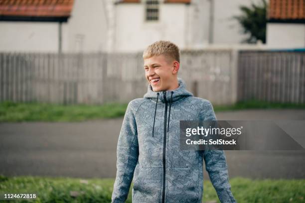 teenager boy laughing - boy happy blonde stock pictures, royalty-free photos & images