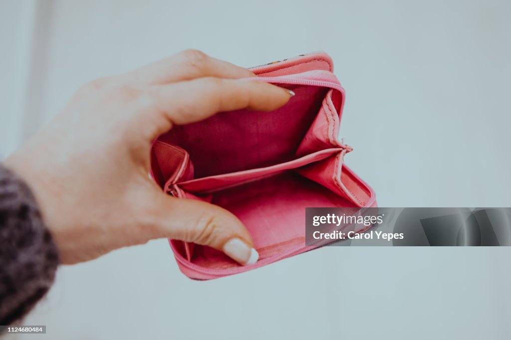 Woman hand holding empty wallet