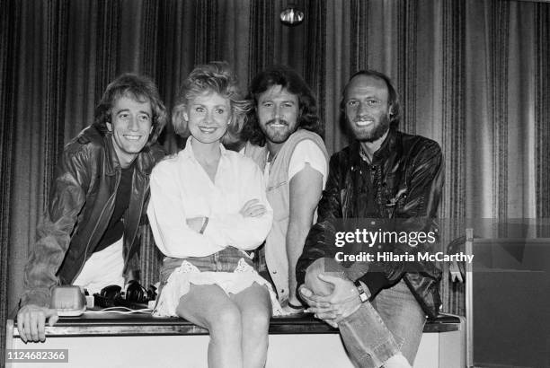 Scottish singer-songwriter and actress Lulu with Robin, Barry and Maurice Gibb of pop group The Bee Gees, UK, 29th August 1983.