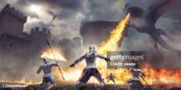 medieval knights being attacked by fire breathing dragon near castle - dragão imagens e fotografias de stock