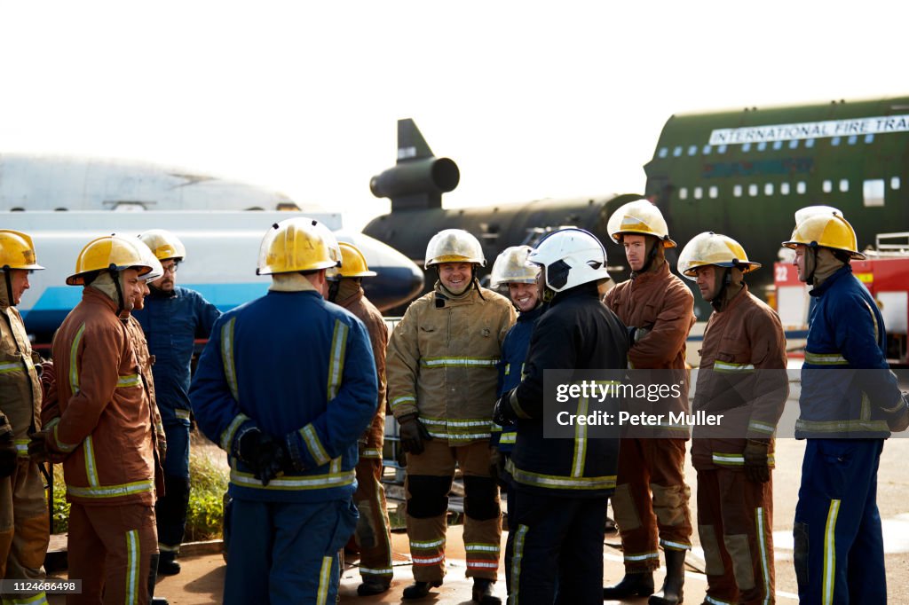 Firemen training, large group of firemen listening to supervisor