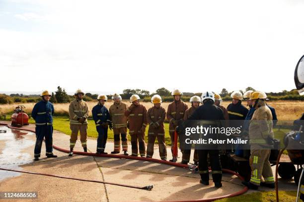 firemen training, team of firemen listening to supervisor at training facility - international firefighters day stock pictures, royalty-free photos & images