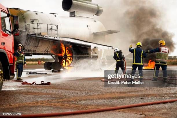 firemen training, spraying water at mock airplane engine - airplane engine fire stock pictures, royalty-free photos & images