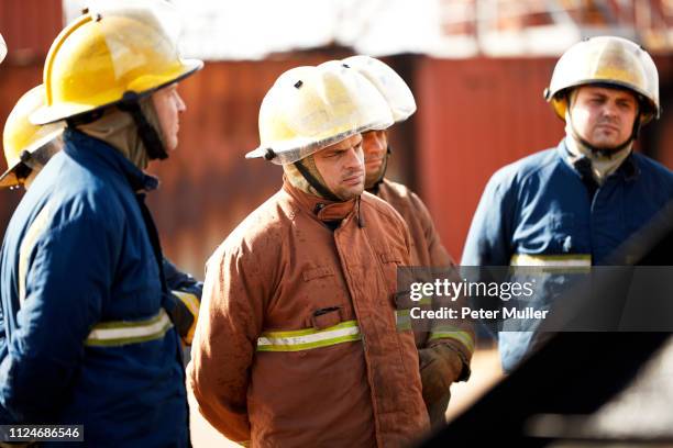 firemen training, team of firemen listening to supervisor at training facility - international firefighters day stock pictures, royalty-free photos & images