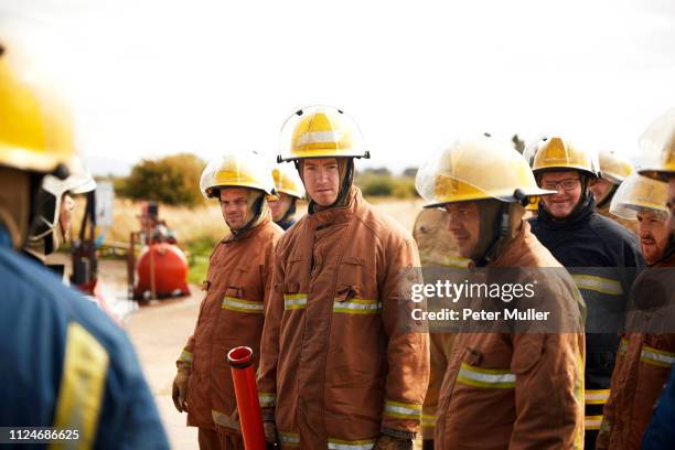 firemen training, team of firemen listening at meeting at training facility - international firefighters day 個照片及圖片檔