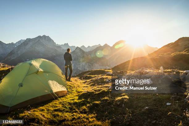 hiker by tent enjoying view, karwendel region, hinterriss, tirol, austria - hiking across the karwendel mountain range stock pictures, royalty-free photos & images