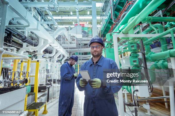 portrait of engineer in turbine hall in nuclear power station - turbine hall stock pictures, royalty-free photos & images