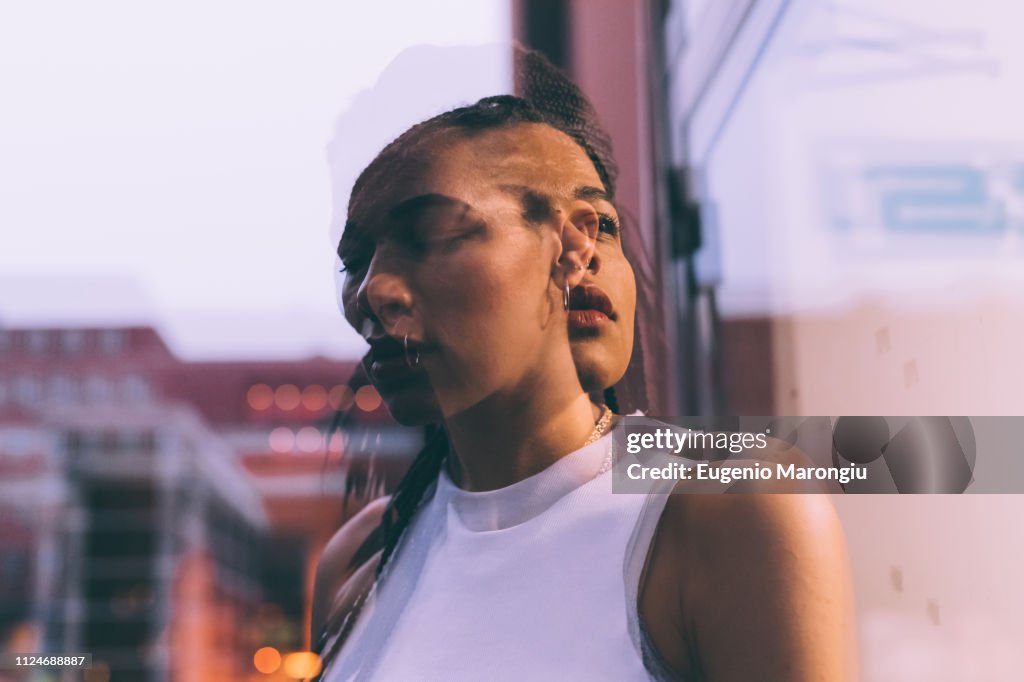 Woman beside glass window