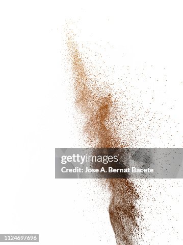 Explosion by an impact of a cloud of particles of powder of color brown on a white background. Explosion by an impact of a cloud of particles of powder of color brown on a white background.