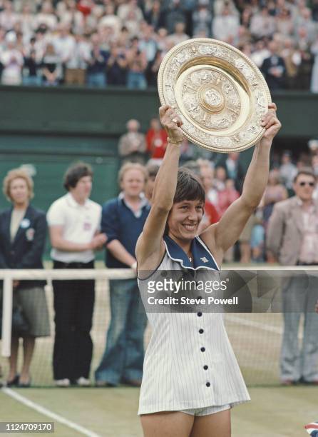 Martina Navratilova of the United States holds the Rosewater Plate aloft after winning the Ladies Singles Final match against Chris Evert at the...