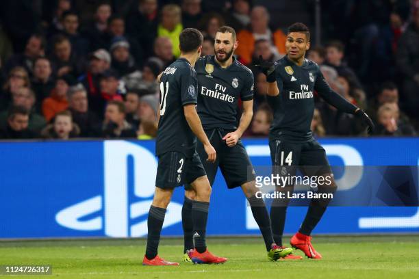 Karim Benzema of Real Madrid celebrates after scoring his team's first goal with Sergio Reguilon of Real Madrid and Casemiro of Real Madrid during...