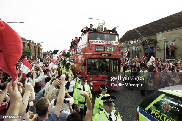 Manchester United celebrate winning the treble as the jubilant team make their way through Manchester during an open top bus parade. Sir Alex...