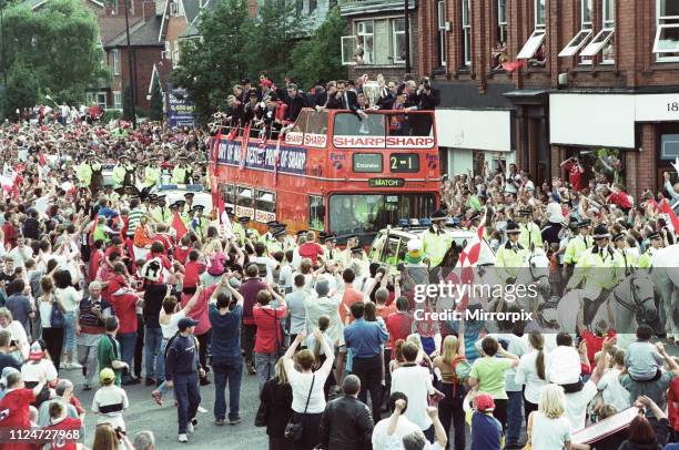 Manchester United celebrate winning the treble as the jubilant team make their way through Manchester during an open top bus parade. 27th May 1999.