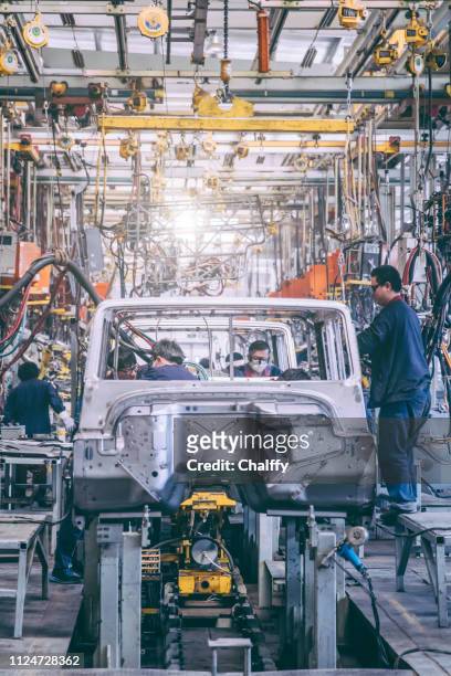 automobile factory welding assemble line - automobile industry stock pictures, royalty-free photos & images