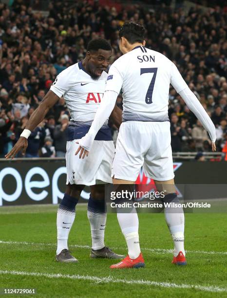 Heung-Min Son of Tottenham celebrates scoring the opening goal with Serge Aurier during the UEFA Champions League Round of 16 First Leg match between...