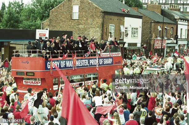 Manchester United celebrate winning the treble as the jubilant team make their way through Manchester during an open top bus parade. 27th May 1999.