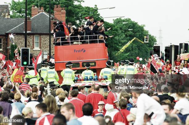 Manchester United celebrate winning the treble as the jubilant team make their way through Manchester during an open top bus parade. 27th May 1999.