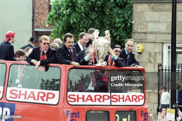 Manchester United celebrate winning the treble as the jubilant team make their way through Manchester during an open top bus parade. Sir Alex...