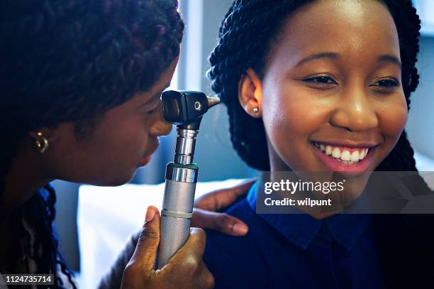 esame otoscopio diagnostico professionale sorridente - otoscope foto e immagini stock