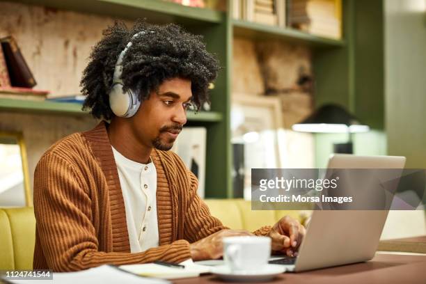 young businessman using laptop in creative office - smart casual stock pictures, royalty-free photos & images
