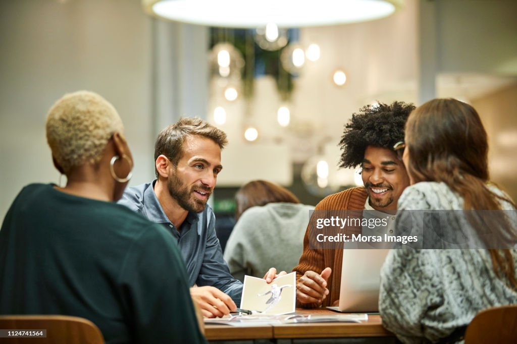 Multi-ethnic coworkers discussing in office