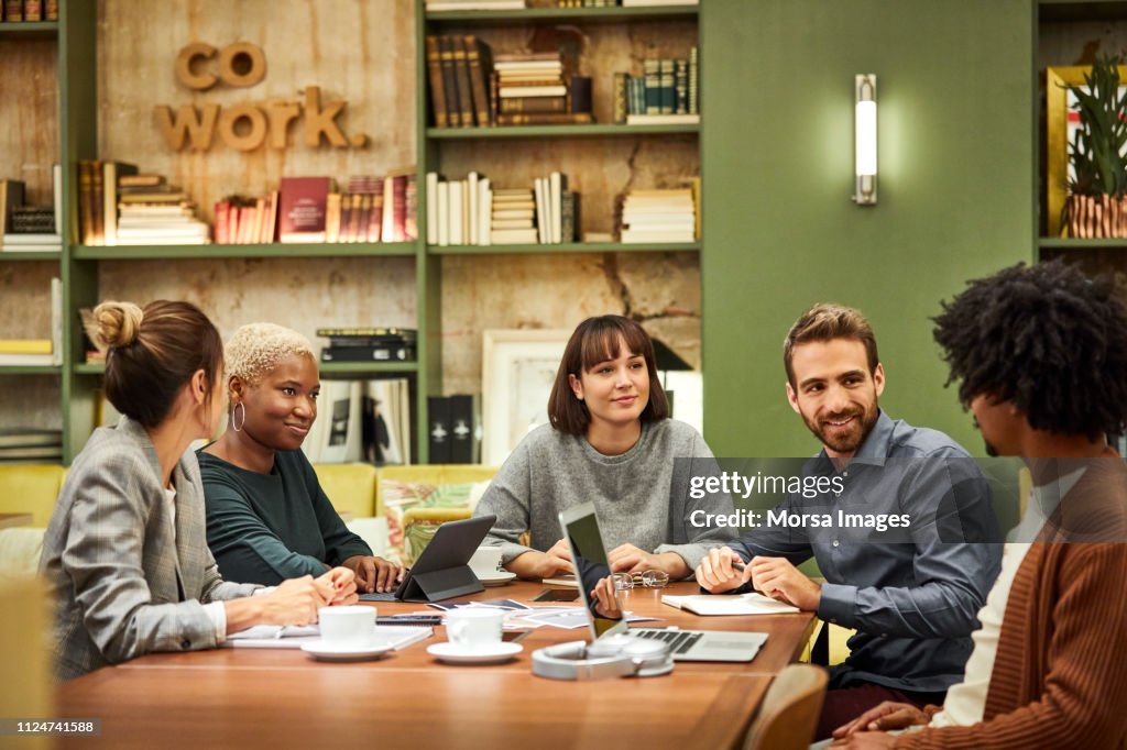 Male and female colleagues discussing in office