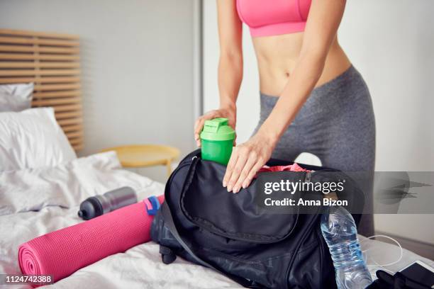 woman preparing gym bag for all day. chorzow, poland - gym bag fotografías e imágenes de stock
