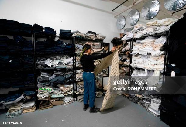 Customers choose fabrics to buy at Fabscrap on February 1, 2019 at the company's warehouse in New York. - The fashion industry generates tons of...