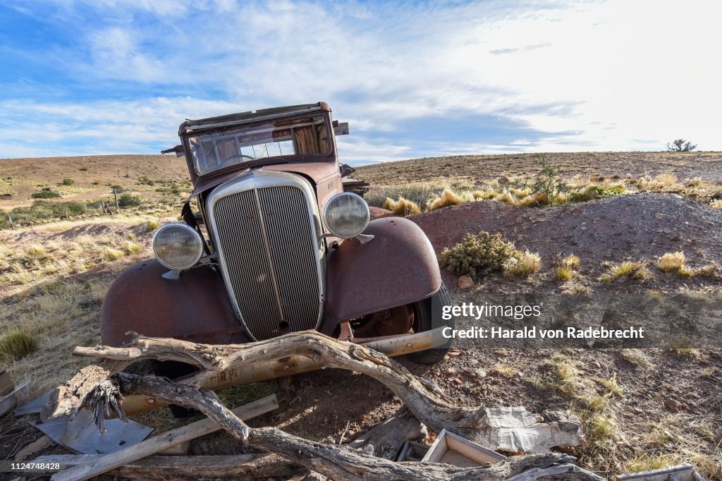 Pampa with old car on a farm in Bosques Petrificados de Jaramillo National Park, Patagonia, Argentina