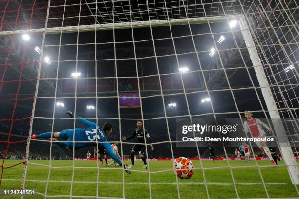 Thibaut Courtois of Real Madrid dives to save a shot from Hakim Ziyech of Ajax but fails and Ajax score there first goal during the UEFA Champions...