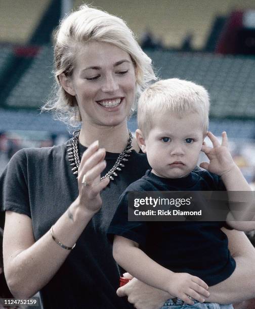 October 1996: Supermodel Elaine Irwin - Mellencamp and Son Hud Mellencamp backstage during Farm Aid at William - Brice Stadium in Columbia, SC. On...