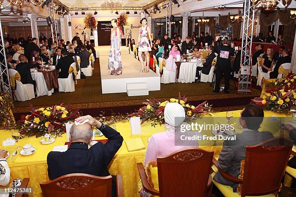 Mohamed Al Fayed , Queen Tuanku Nur Zahirah of Malaysia and King Tuanku Mizan Zainal Abidin of Malaysia watch the launch ceremony for an in-store...