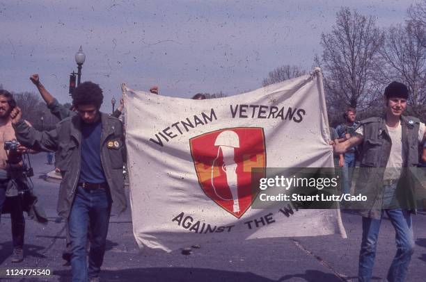 Close-up of two men carrying a banner reading "Vietnam Veterans Against the War, " during demonstrations related to the Vietnam War May Day Protests,...