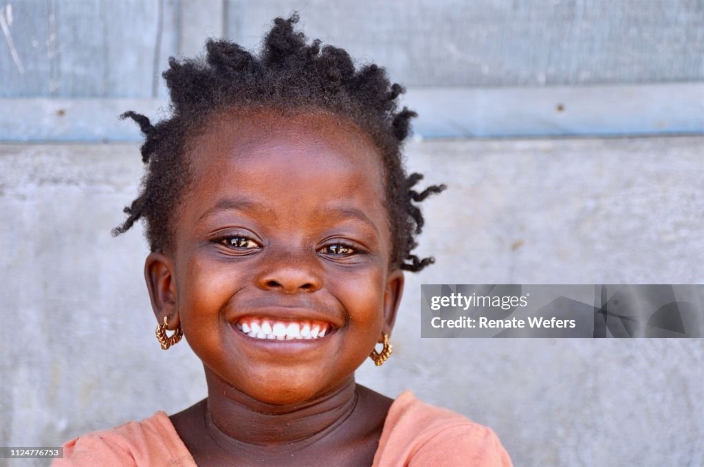 Retrato de una chica sonriente contra la pared