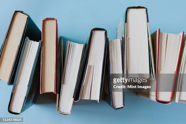 arrangement of hardback books - stack of books stock pictures, royalty-free photos & images