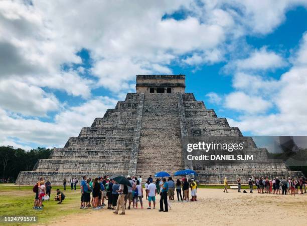 People visit the Kukulcan Pyramid at the Mayan archaeological site of Chichen Itza in Yucatan State, Mexico, on February 13, 2019.