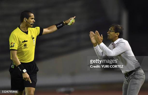 Ecuador's Delfin coach Fabian Bustos argues with Brazilian referee Ricardo Marques Ribeiro during a Copa Libertadores football match against...