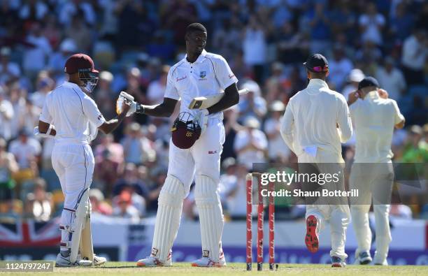 West Indies captain Jason Holder is congratulated by team-mate Shane Dowrich after reaching his 150 during Day Three of the First Test match between...