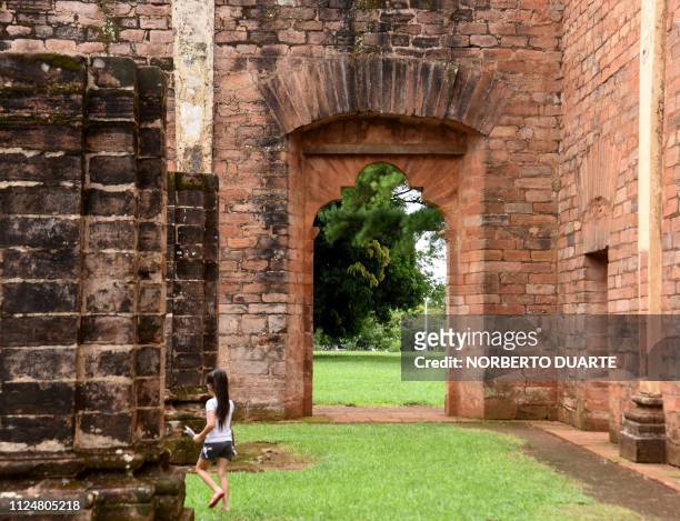 Tourists visit the ruins of the Jesus de Tavarangue Jesuit mission, 412 km south of Asuncion, on January 18, 2019. - Paraguay is proposing the...