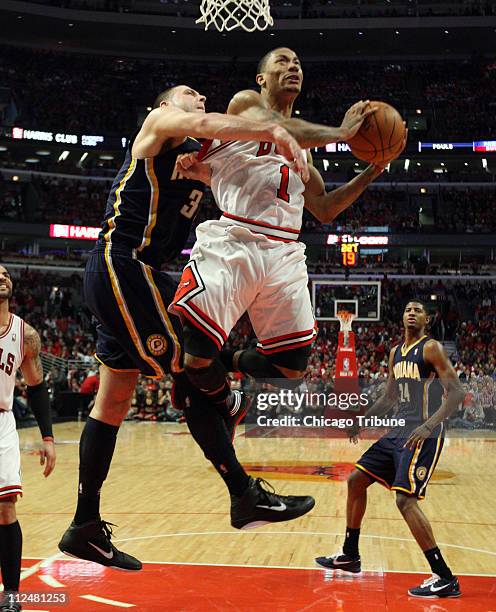 Indiana Pacers power forward Josh McRoberts fouls Chicago Bulls point guard Derrick Rose during second-quarter action in Game 2 of the NBA Eastern...