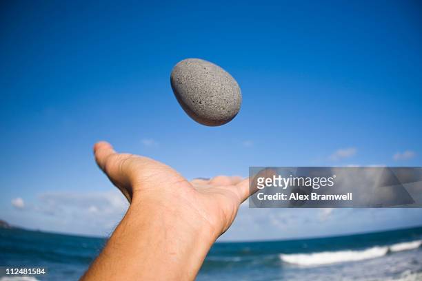 pebble in the air - flicking stock pictures, royalty-free photos & images
