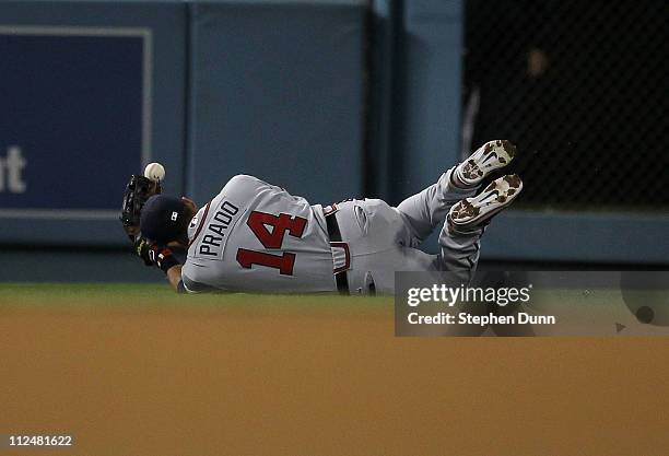 Left fielder Martin Prado of the Atlanta Braves loses the ball as he makes a diving attempt to catch a single hit by Casey Blake of the Los Angeles...