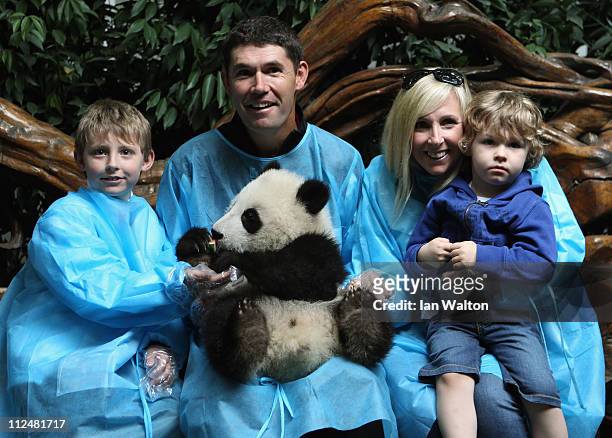 Padraig Harrington of Ireland and his family, pose for photos with a baby Panda during a visit to the Chengdu Research Base of Giant Panda Breeding...