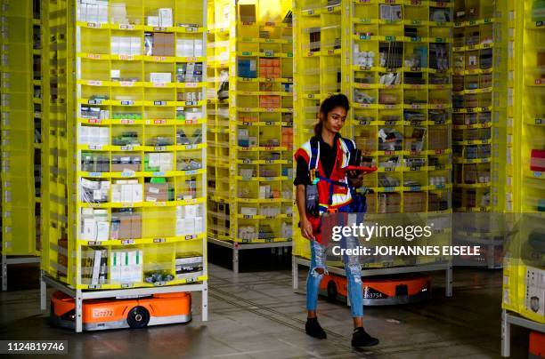 Woman uses a computer to control robots at the 855,000-square-foot Amazon fulfillment center in Staten Island, one of the five boroughs of New York...