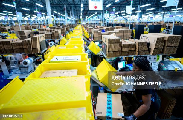 Woman works at a packing station at the 855,000-square-foot Amazon fulfillment center in Staten Island, one of the five boroughs of New York City, on...