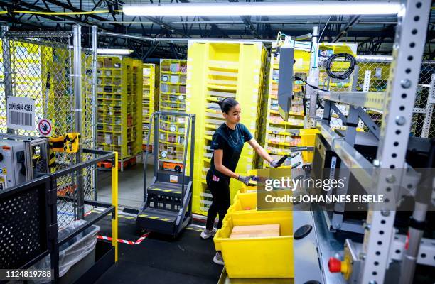 Woman works at a distrubiton station at the 855,000-square-foot Amazon fulfillment center in Staten Island, one of the five boroughs of New York...