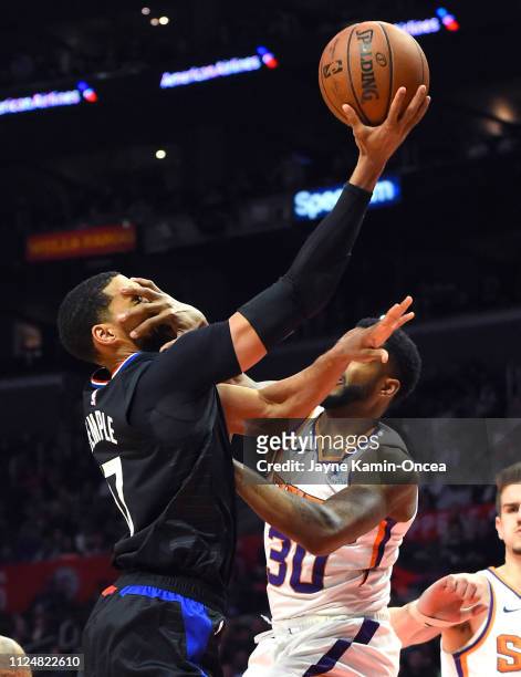 Garrett Temple of the Los Angeles Clippers is fouled by Troy Daniels of the Phoenix Suns as he drives to the basket in the second half of the game at...