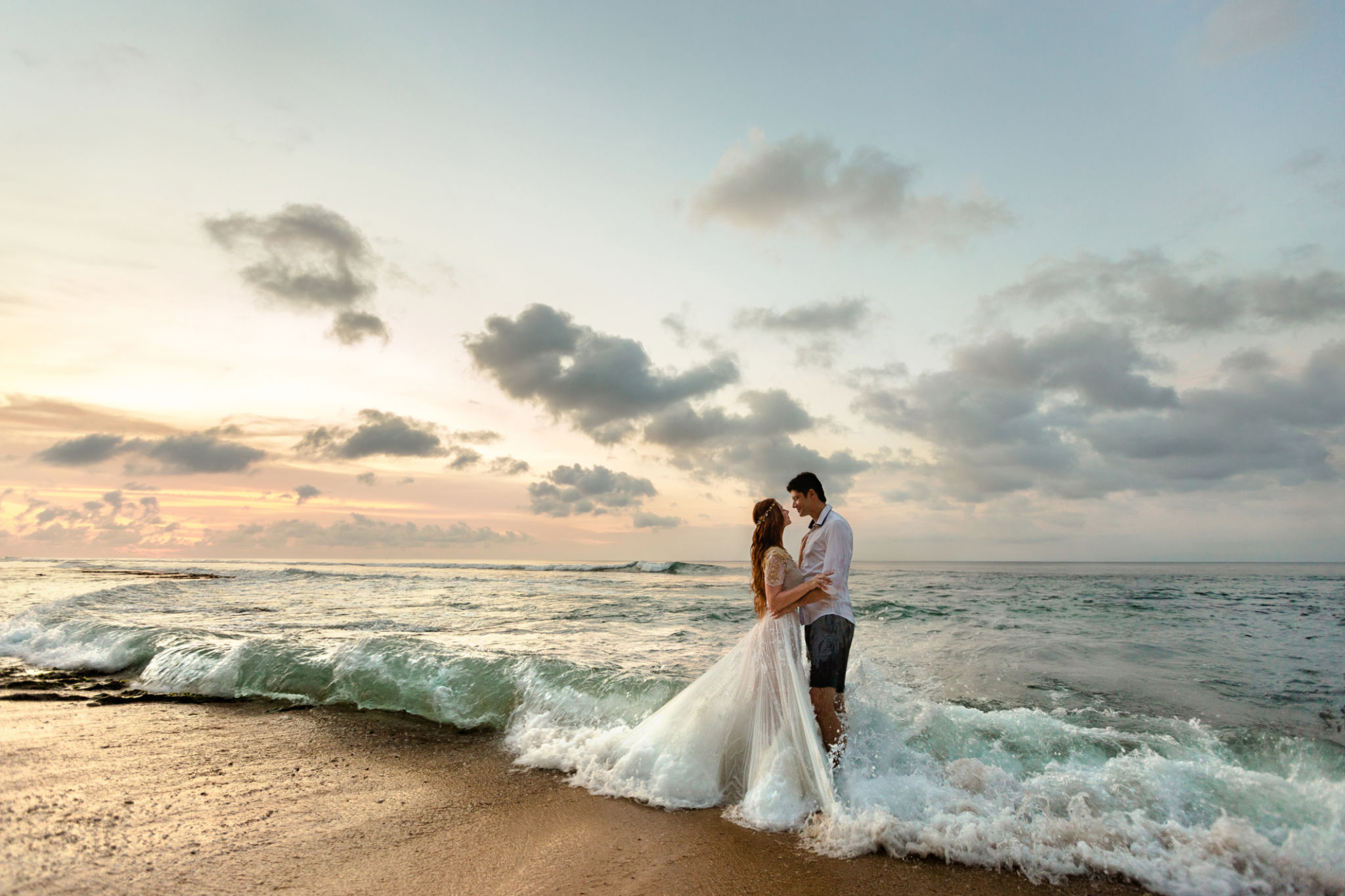 Newlyweds on the beach at sunset Newlyweds on the beach at sunset