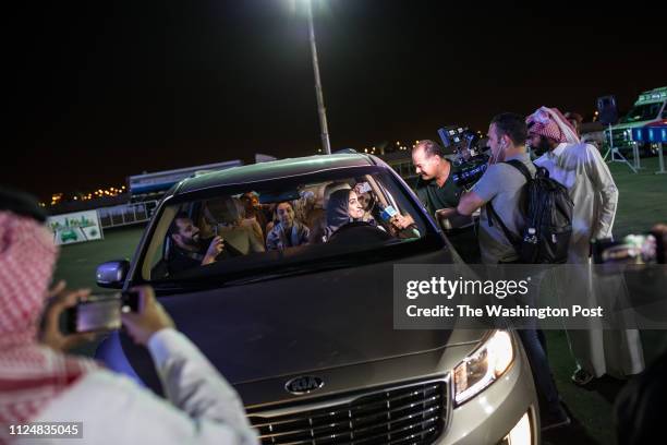 At exactly midnight, on June 24, the day the ban on women driving in Saudi is lifted, a woman is interviewed by local and foreign journalists as she...